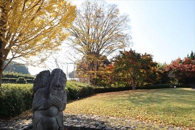 水を噴水する石人像と紅葉の画像